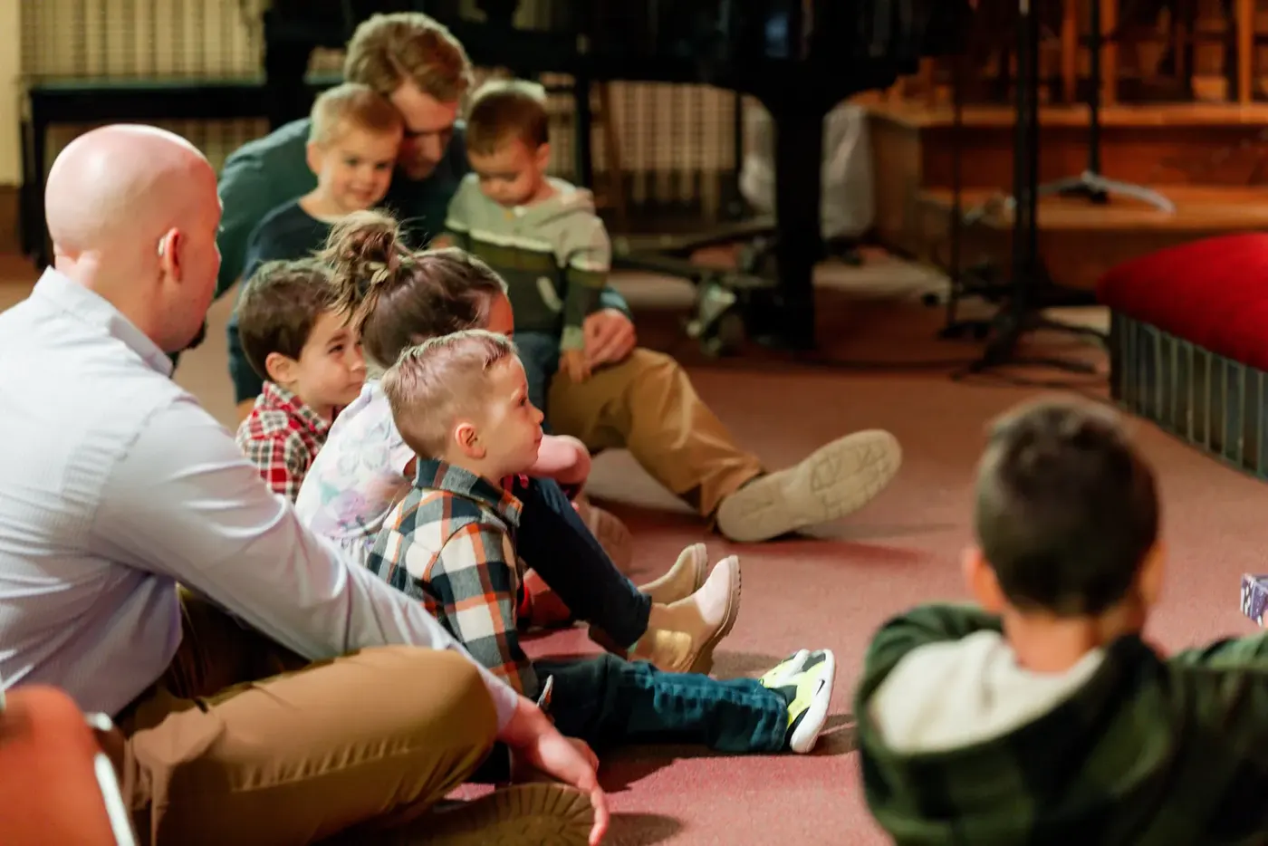 Children gathered on the floor during the children’s message at Emmaus